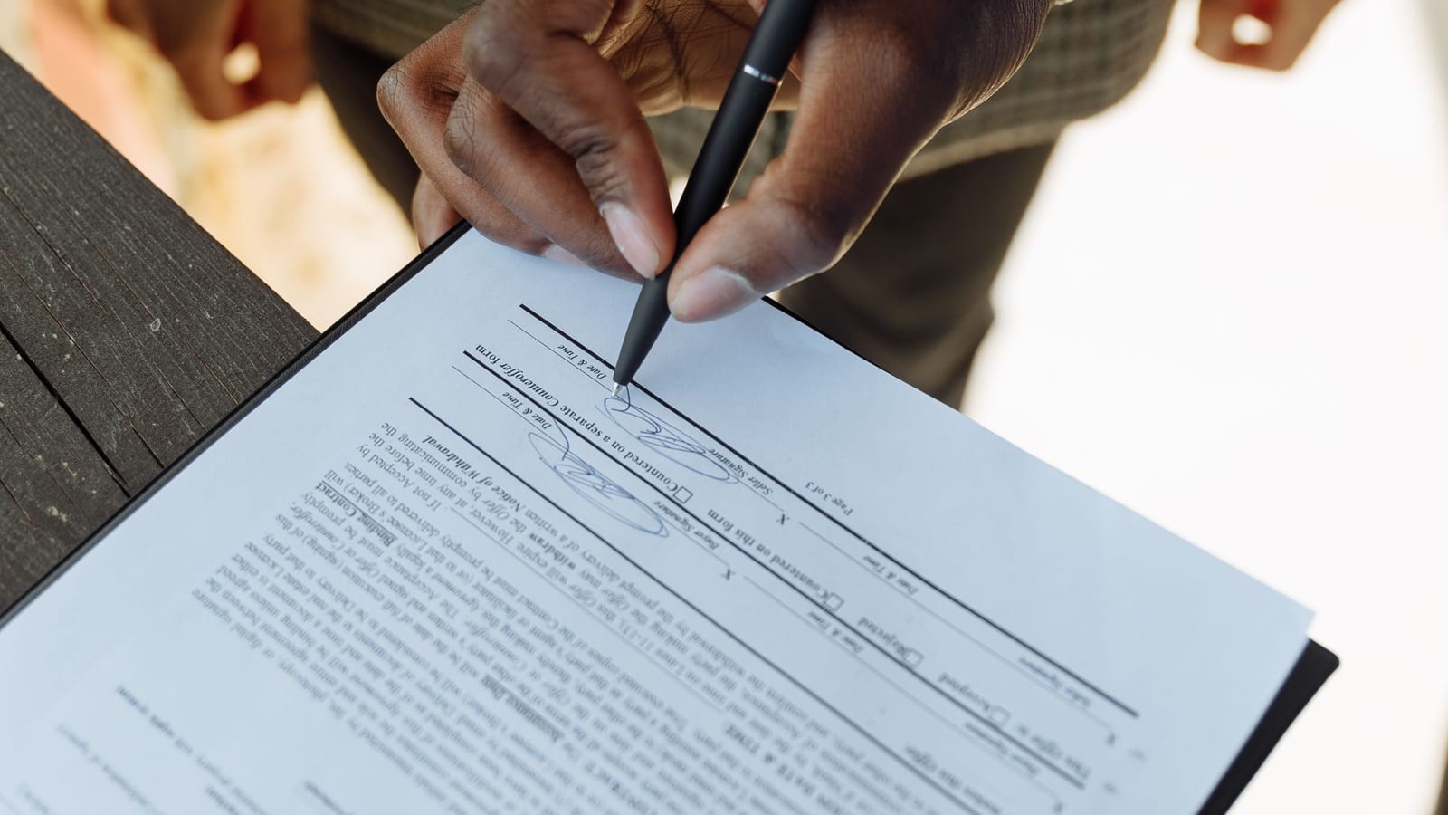 Signing a property contract on a clipboard