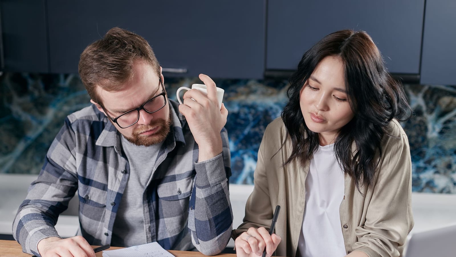 Couple reviewing their bills and borrowing capacity at the kitchen table